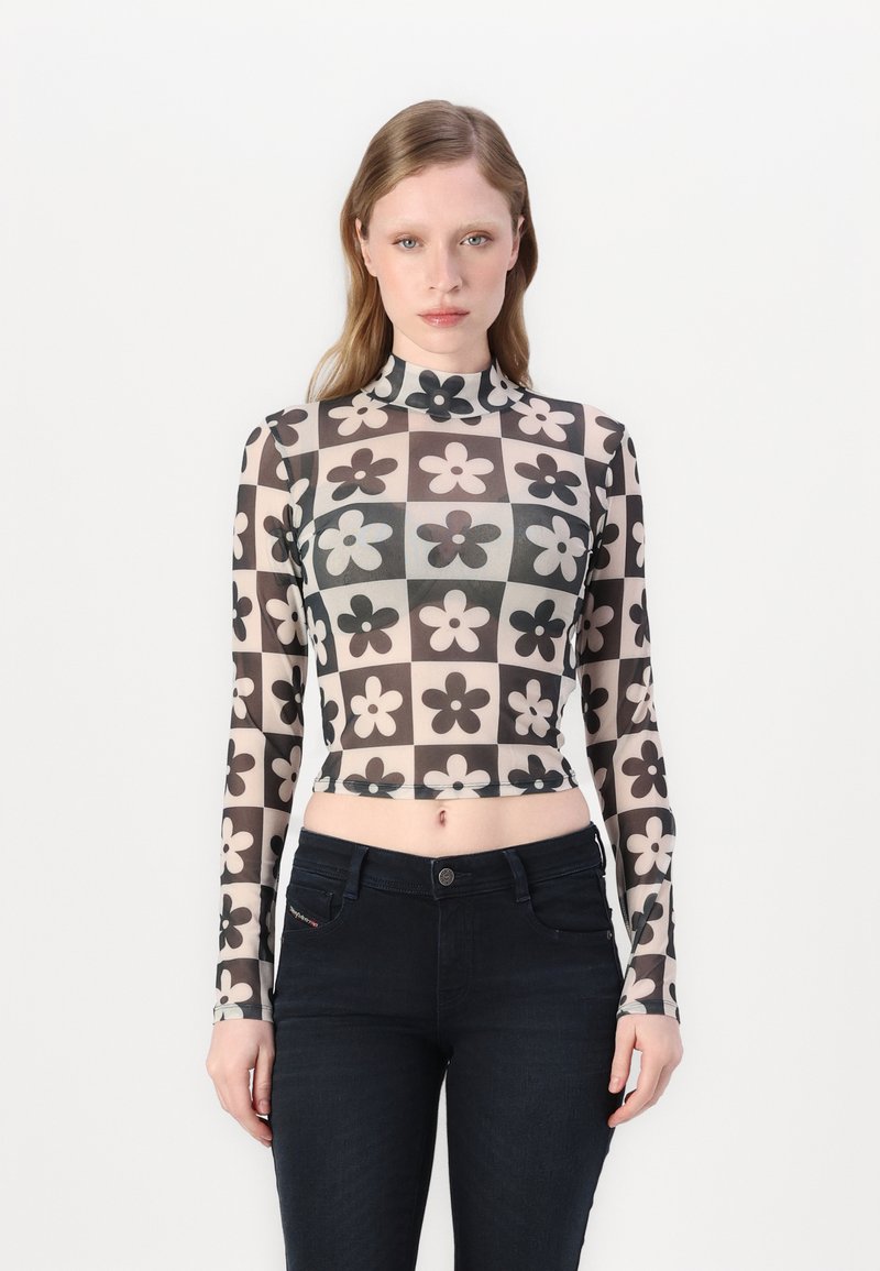 Dlhý rukáv, crop top vyrobený z priesvitnej látky s monochromatickým kvetinovým vzorom usporiadaným do mriežky. Vysoký golier a priliehavý strih.