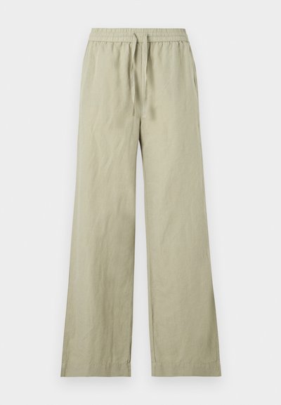 Ανοιχτό μπεζ παντελόνια φαρδύ με ελαστική μέση και κορδόνι, επίπεδη μπροστινή όψη και πλαϊνές τσέπες, εμφανίζονται σε λευκό φόντο.