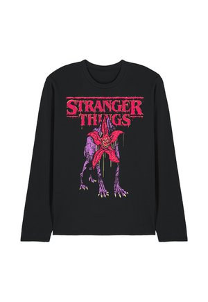 Schwarzes Langarmshirt mit rotem "Stranger Things"-Schriftzug und Grafik eines violetten Monsters mit offenem, roten, blumenähnlichem Gesicht.