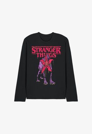 Black long-sleeve shirt with red "Stranger Things" text and graphic of a purple monster with an open red flower-like face.