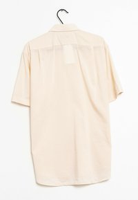 Kortärmad, ljusbeige skjorta med knappar, som har en klassisk krage och lös passform med en central ryggdetalj.