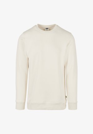 Krém színű pulóver puha anyagból. Kerek nyakkivágással, passzés hosszú ujjal és varrott szegéllyel rendelkezik. Minimalista, minták nélküli kialakítás.