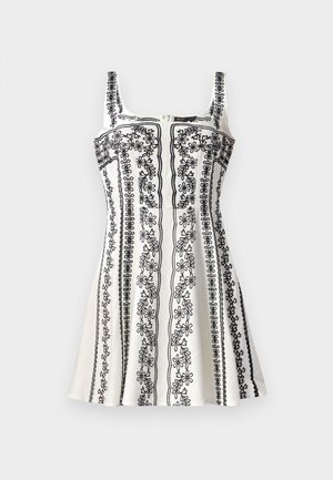 Vestido sin mangas en blanco y negro con intrincado bordado floral, un corsé ajustado y una falda acampanada. Tejido texturizado con cremallera.