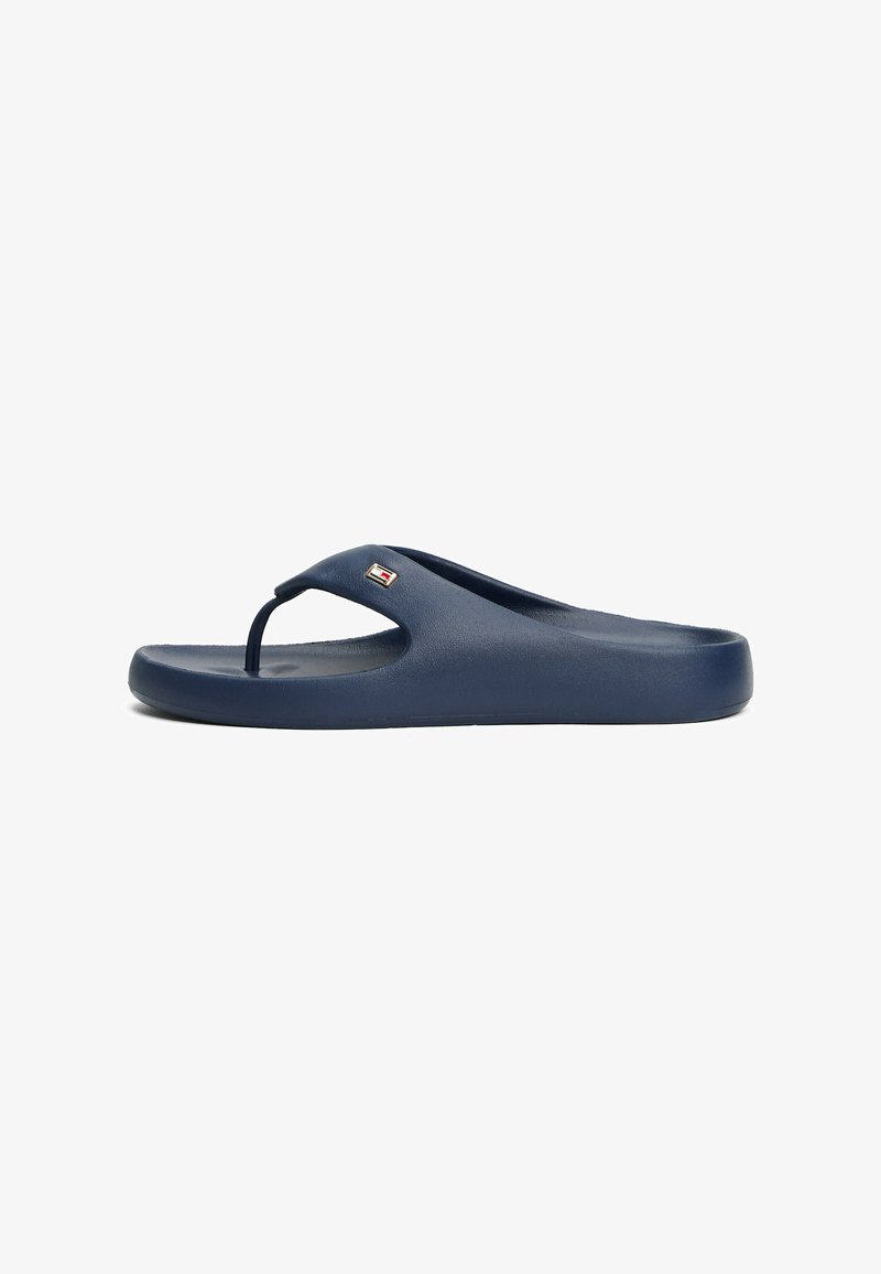 Navy flip-flop sandal made of rubber with a textured sole, featuring a Y-shaped strap and a small logo detail on the side.