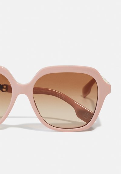 Pink plastic sunglasses with large square lenses, gradient brown tint, and a subtle gold accent on the temple. Made in Italy.