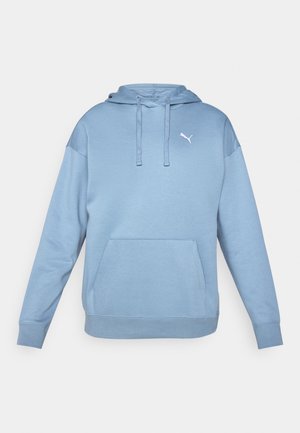 Lys blå hettegenser laget av myk stoff, med en frontlomme, snor til hetta og en liten hvit logo på brystet.
