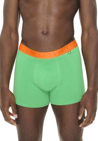 Green cotton boxer briefs with a wide orange waistband featuring the word "HAPPY" embossed. Smooth texture and fitted design.