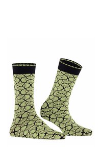 Gemusterte Socken in Minzgrün mit schwarzen Blätternmotiven. Mit schwarzen Rippbündchen mit gewellten Kanten für zusätzliche Details. Weicher Stoff. 