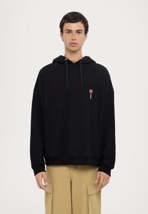 Black hoodie with a relaxed fit, made of soft fabric. Features a small embroidered lollipop design on the chest, with drawstrings at the hood.