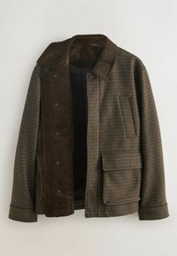 Brown checked corduroy jacket with a collar, snap buttons, a large front pocket, and an inner layer showcasing dark fabric.