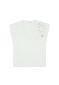 V-neck, short-sleeve top in light green fabric featuring sunburst embroidery in gold and yellow on the left shoulder.