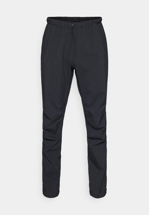 Zwarte lichtgewicht broek met een elastische tailleband, trekkoorden en taps toelopende benen. Gemaakt van waterafstotend materiaal met een gladde textuur.