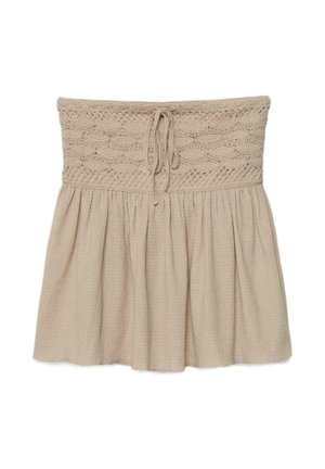 Beige trägerloser Rock mit gehäkeltem, elastischem Bund und Kordelzug, darunter ein geraffter, strukturierter Stoff.