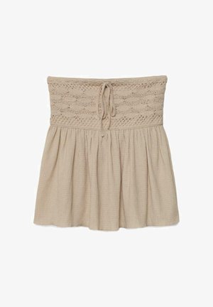 Beige stropløs nederdel med en hæklede, elastisk talje og snøre, med et rynket, tekstureret stof under taljen.