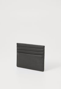 Black leather cardholder with textured surface, featuring multiple card slots and a minimalist design, no visible logos or hardware accents.