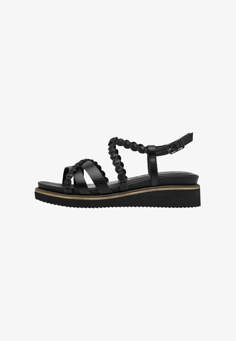 Sandal nera con suola platform, caratterizzata da cinturini in pelle testurizzata e un design intrecciato sulla caviglia. Cinturino regolabile con fibbia in metallo.