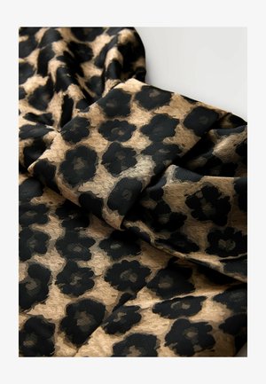 Leopardimustriga kangas, millel on musta tekstuuriga lillemuster kullavärvilisel taustal, pehmed voldid paljastavad selle kerge struktuuri.