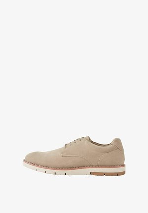 Beige suede men's lace-up shoe with white and brown rubber sole, visible stitching, and minimalist design shown in side profile.