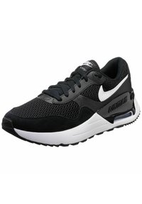 Sneaker sportiva in bianco e nero con materiali in rete e suede, colletto imbottito, chiusura con lacci e un'unità Air visibile nella suola.