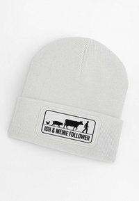 Gray knit beanie featuring a rectangular black patch with farm animal silhouettes and the text "ICH & MEINE FOLLOWER" in black.