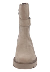 Beige suede ankle boot with a rounded toe, side zipper, and adjustable strap detail. Thick rubber sole with textured tread.
