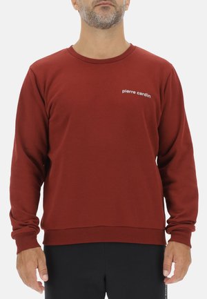 Maroon sweatshirt with long sleeves, round neckline, ribbed cuffs and hem, featuring white "pierre cardin" text on the chest.