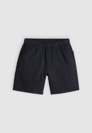 Sorte shorts med strukturert stoff, elastisk midjebånd, sidelommer og en avslappet passform.