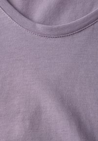 T-shirt in cotone lilla con scollatura rotonda e texture a costine finissime. Il tessuto appare morbido e liscio con una leggera elasticità.