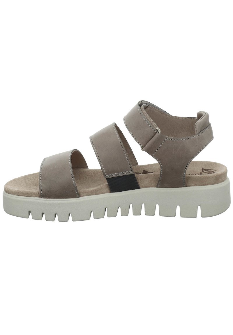 Brown leather sandals with three wide straps and a cushioned footbed. Chunky white rubber sole with a serrated edge for traction.