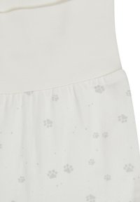 White fabric with a gathered seam, printed with small gray paw prints scattered across the surface.