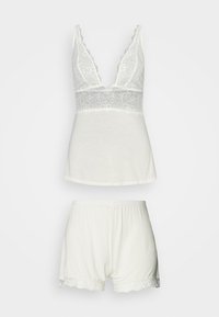 Witte katoenen pyjama set met een V-hals top met kantafwerking en bijpassende shorts met een elastische tailleband en kantaccenten.