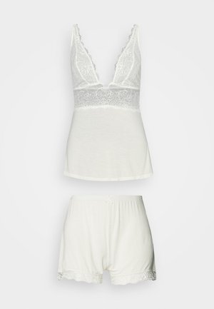 Witte katoenen pyjama set met een V-hals top met kantafwerking en bijpassende shorts met een elastische tailleband en kantaccenten.