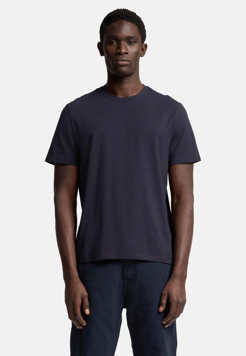 Marinblå kortärmad T-shirt i bomull, med rund halsringning och avslappnad passform. Mjuk textur, enkel design, inga synliga logotyper.