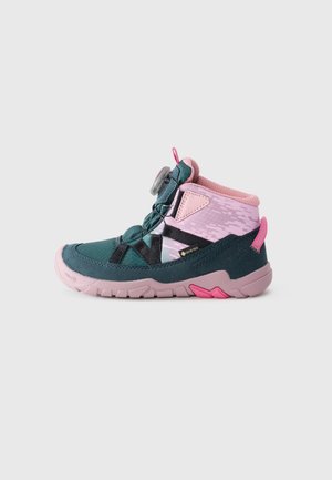 Mid-height waterproof shoe featuring pink and teal fabric, textured materials, elastic laces, and a grey dial for adjustment.