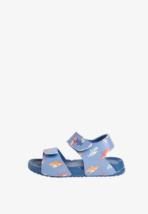 Blå børnesandal med justerbare stropper, dekoreret med farverige hajillustrationer og en tekstureret sål for greb.