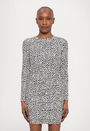 Long-sleeve dress featuring a black and white spotted pattern, round neckline, and a fitted silhouette with gathered texture at the waist.