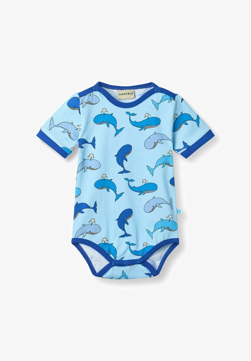 Svetlomodrý detský overal s tmavomodrým lemovaním, zdobený rôznymi modrými kreslenými veľrybami striekajúcimi vodu.