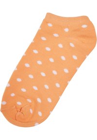 Orange sok med hvide prikker, lavet af blødt stof. Har en rund tå og ribbet manchette.