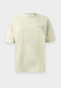 Pale green oversized t-shirt with short sleeves, featuring a small black "Samsøe Samsøe" logo on the left side near the chest.