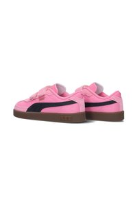 Pink Puma sneakers with a navy side stripe, featuring a velcro strap and brown rubber sole. Smooth texture with a cushioned interior.