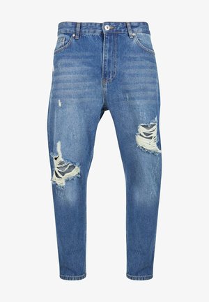 Heledad sinise denimi teksad, millel on põlvete kohal kulunud rebendid, viie taskuga disain ja kitsenev lõige. Pleekinud tekstuur koos peente kulumisjälgedega.