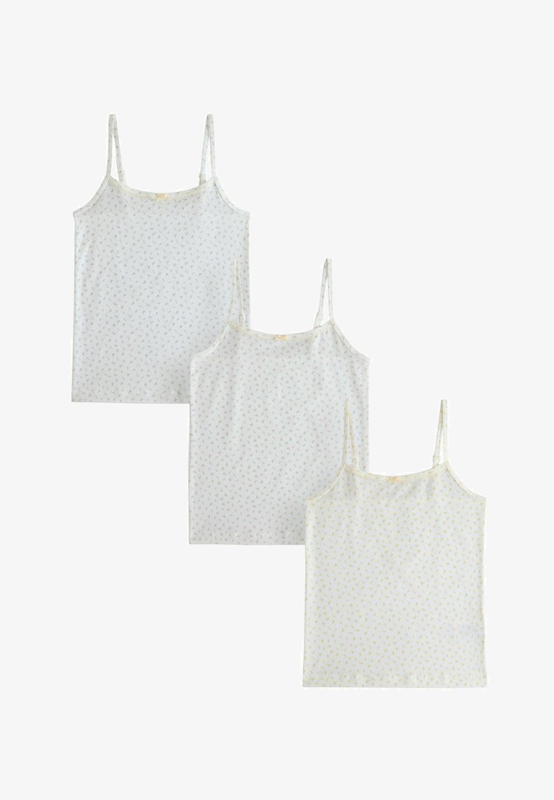 Trois camisoles blanches sans manches avec de délicats petits motifs floraux aux couleurs pastel, exposées en superposition sur un fond blanc.
