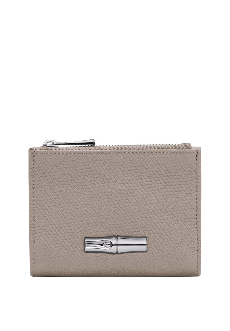 Beige leather wallet with a textured finish, silver hardware, and a zip closure. Features a prominent metallic accent on the front.