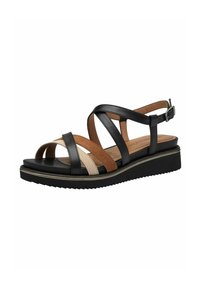 Sandale en cuir noir et marron avec des sangles entrecroisées, une fermeture à boucle et une semelle intérieure rembourrée sur une semelle à petit talon. Semelle extérieure crantée pour plus de stabilité.