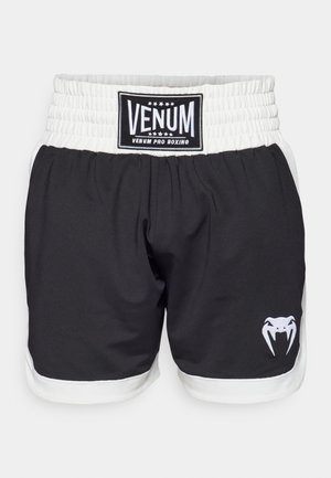 Shorts de boxe noirs avec une ceinture blanche, arborant un logo VENUM et un graphisme de serpent en blanc. Fabriqués en matériau léger et durable.