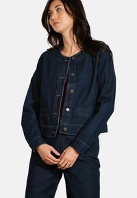 Veste en denim bleu foncé, au design court avec un col rond, fermeture à boutons à l'avant, et deux poches latérales. Détails de couture classiques.