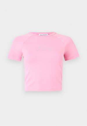Light pink short-sleeve crop top with a round neckline and sparkling "Juicy" text centered on the chest.