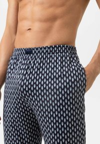 Marineblauwe boxers met een herhaald lichtblauw patroon van fietsen, elastische tailleband, lichtgewicht stof, aansluitende pasvorm en geen zichtbare hardware.