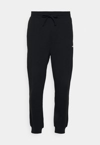 Pantalones de chándal negros de mezcla de algodón, con cintura elástica y cordón ajustable, puños acanalados y un pequeño detalle de logo.