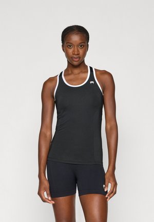 Svart atletisk tanktop med hvite detaljer, laget av teksturert stoff. Har rund halslinning og en logo på venstre bryst. Matchet med svarte shorts.